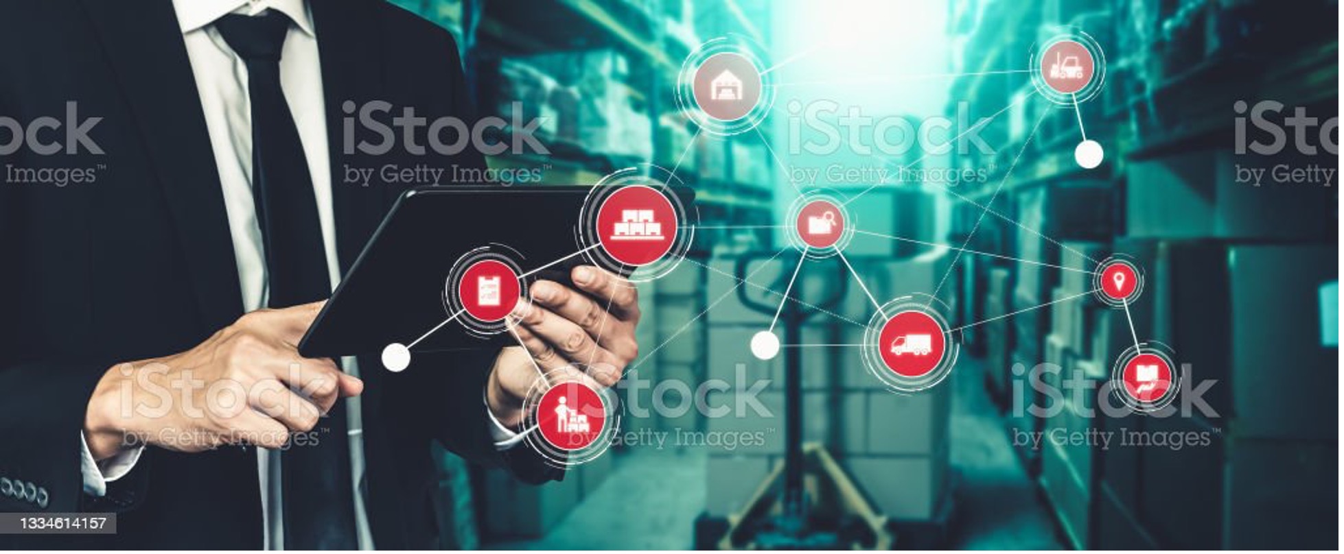 A man with a tablet is his hands and a lot of logistics icons