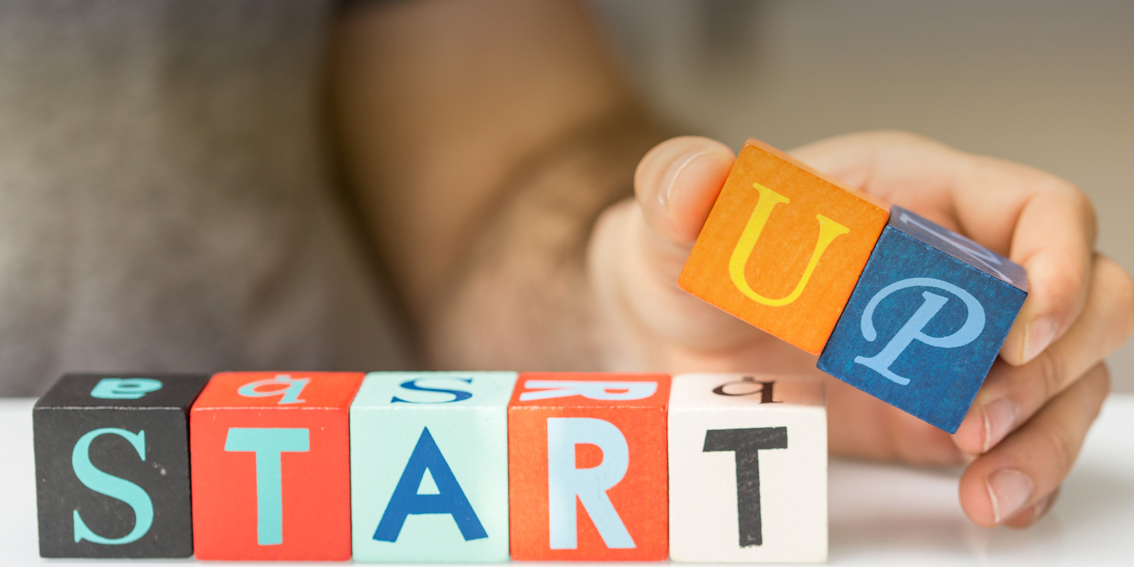 Many cubes of wood with the letter of Startup word
